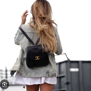CHANEL Black Quilted Backpack with Gold Logo